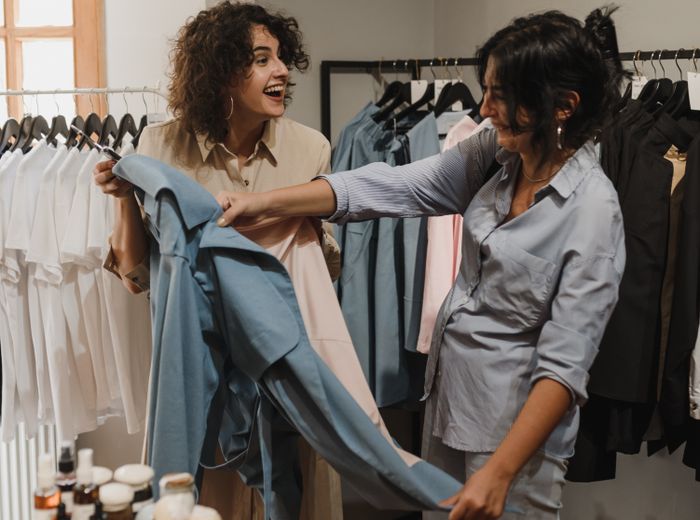 A seller helping a customer in her shop